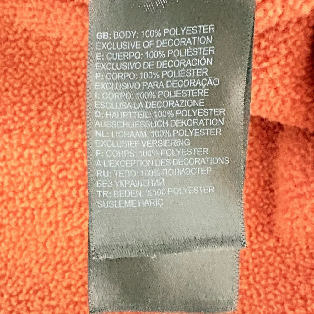 The North Face Textured Cap Rock Quarter Zip Pullover in a rust color
